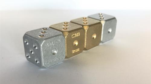 Dice made from engineering metal alloys
