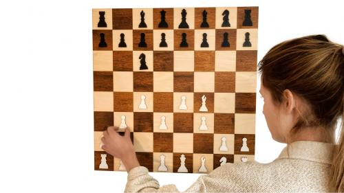 A wooden wall hanging chess board